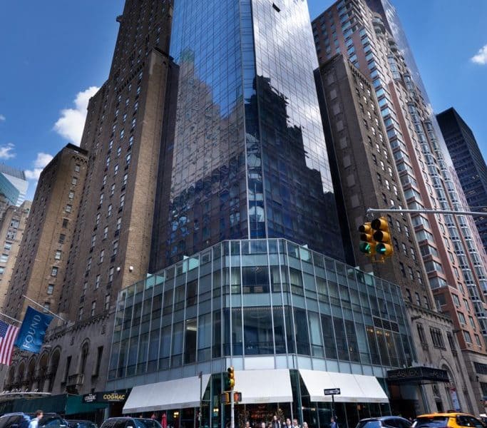 Hotel 48LEX New York exterior view showcasing modern glass architecture in Midtown Manhattan, surrounded by historic buildings and city streets.