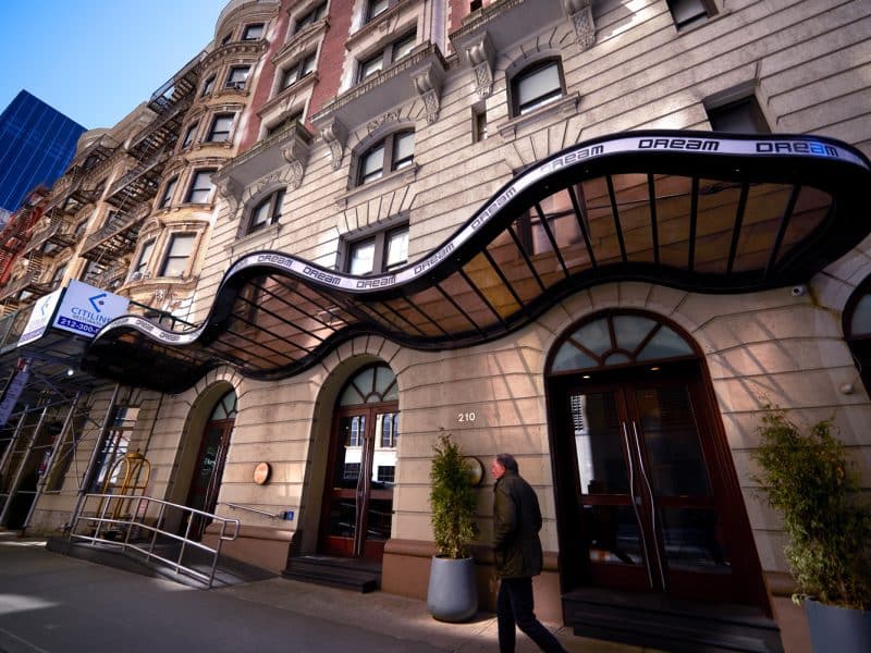 Dream Midtown Hotel entrance with distinctive awning, showcasing stylish architecture and inviting atmosphere in Midtown Manhattan.