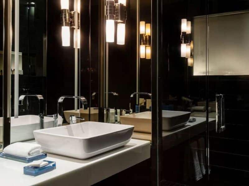 Modern hotel bathroom featuring a stylish sink, elegant lighting, and contemporary fixtures, reflecting the refined atmosphere of Hyatt Centric Wall Street.