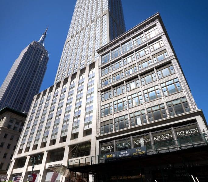 Langham New York, Fifth Avenue building with Empire State Building nearby, showcasing luxury accommodations in Manhattan.