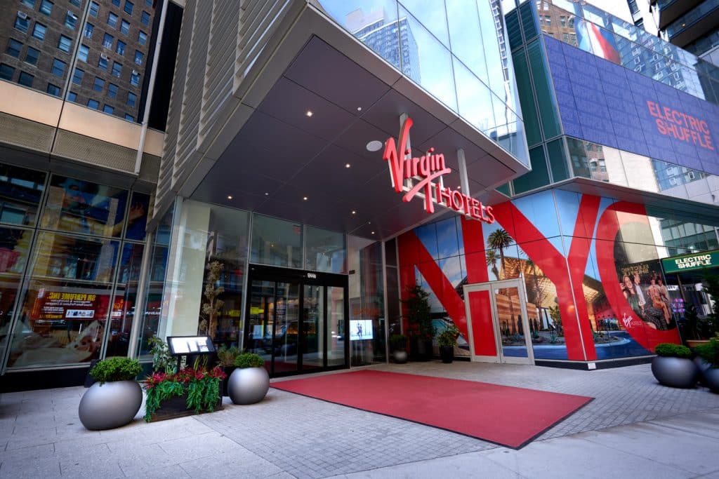 Virgin Hotels New York City entrance with bold signage, modern architecture, and vibrant decor in NoMad, Manhattan.
