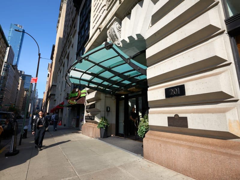 W New York – Union Square hotel entrance with modern awning, street view, and nearby shops in vibrant Manhattan setting.
