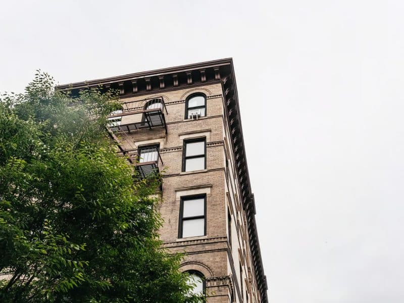 Historic building in downtown NYC with fire escape and greenery, representing locations significant to Taylor Swift's life during a guided tour.