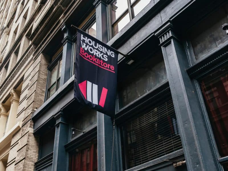 Housing Works Bookstore sign in New York City, featured in Taylor Swift hotspots tour, showcasing cozy literary ambiance and local culture.