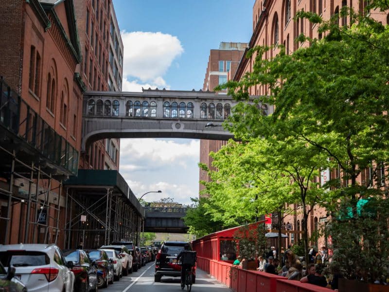 Chelsea Market and High Line view, featuring elevated walkway, vibrant greenery, and urban streetscape, highlighting culinary tour experience in NYC.
