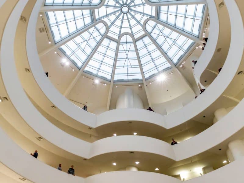 Interior view of the Solomon R. Guggenheim Museum showcasing the iconic spiral architecture and skylight, highlighting its significance as a modern art hub.