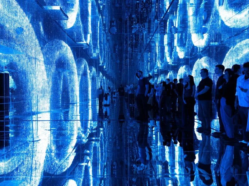 Visitors experiencing immersive blue-lit installation at Mercer Labs Museum of Art and Technology, showcasing interactive art and technology.