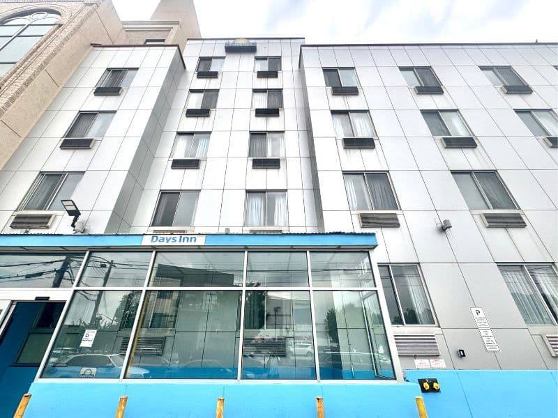 Days Inn by Wyndham Brooklyn Borough Park entrance featuring modern architecture, large windows, and visible signage.