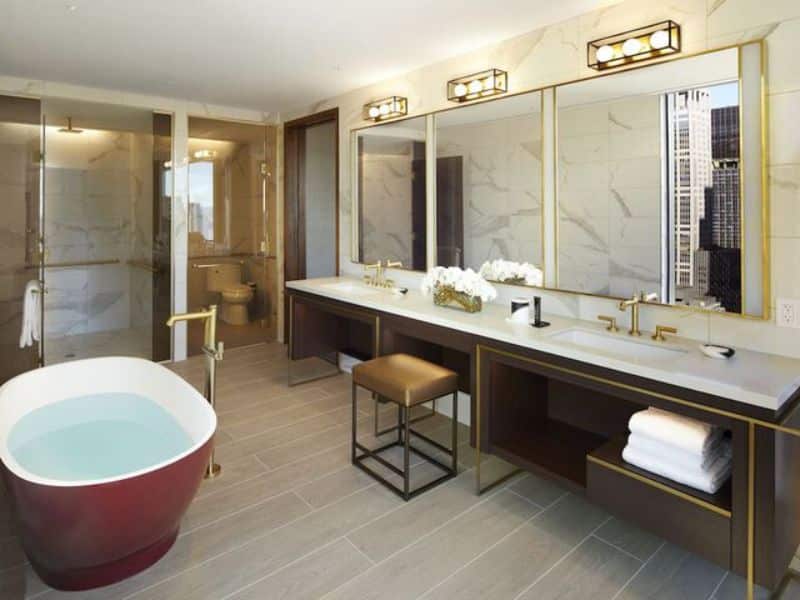 Luxurious hotel bathroom featuring a freestanding bathtub, dual sinks with modern fixtures, and elegant decor, highlighting the upscale amenities of Hard Rock Hotel New York.