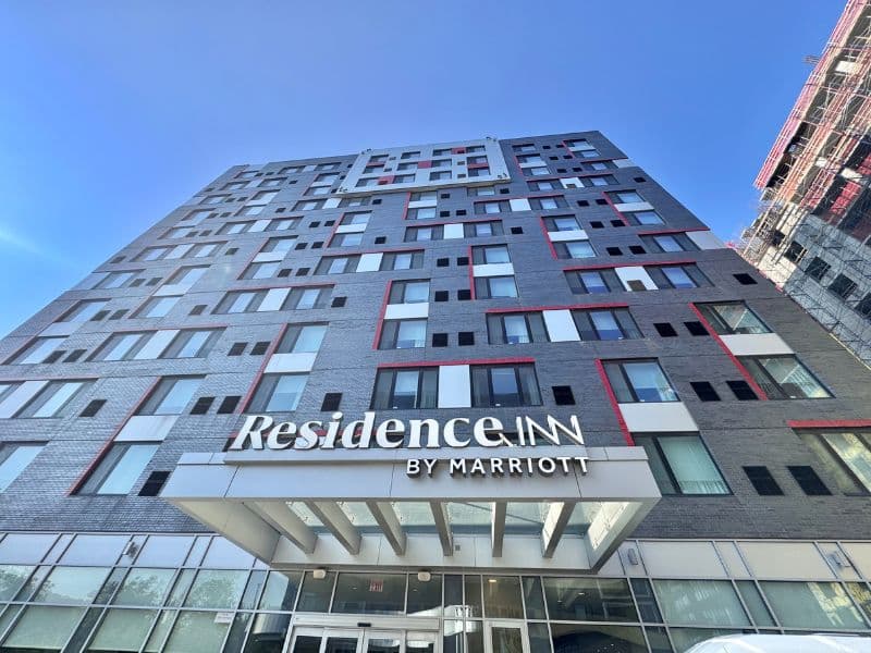 Residence Inn by Marriott building exterior with modern architecture, featuring large windows and prominent signage, located in New York City.