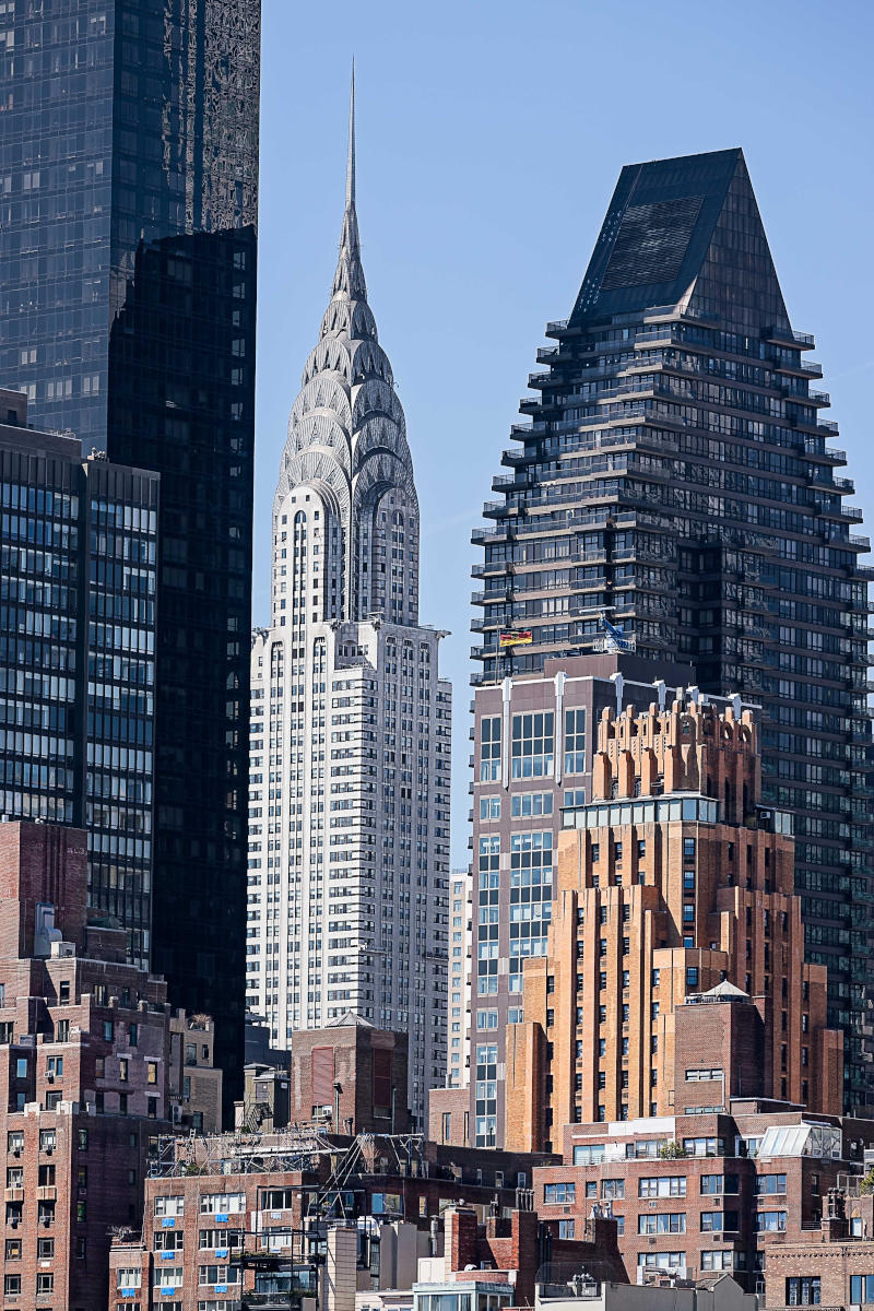 Chrysler Building and modern skyscrapers in Midtown Manhattan, showcasing iconic architecture amidst the NYC skyline.