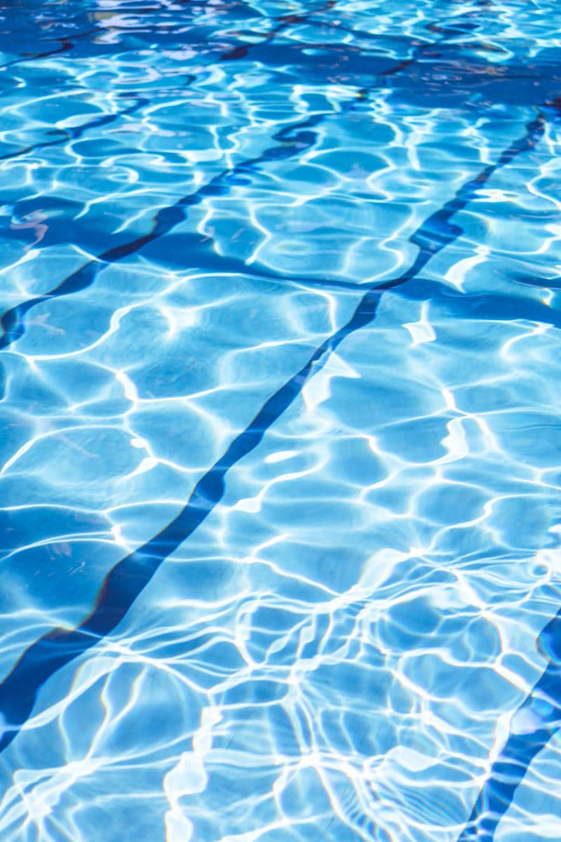 Swimming pool water with shimmering blue reflections, highlighting family-friendly hotel amenities in New York City.