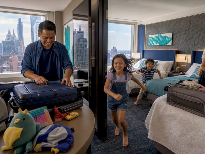 Family using connecting hotel rooms with interior door open