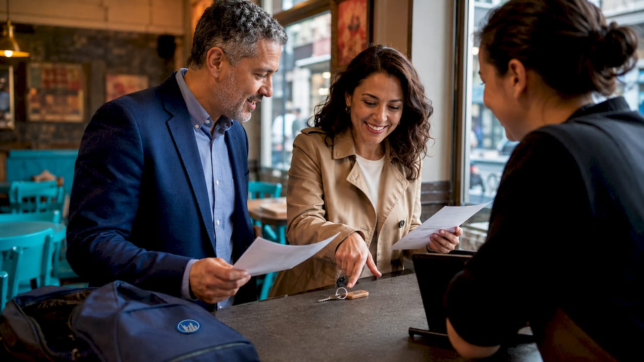 Couple checking into NYC hotel at front desk