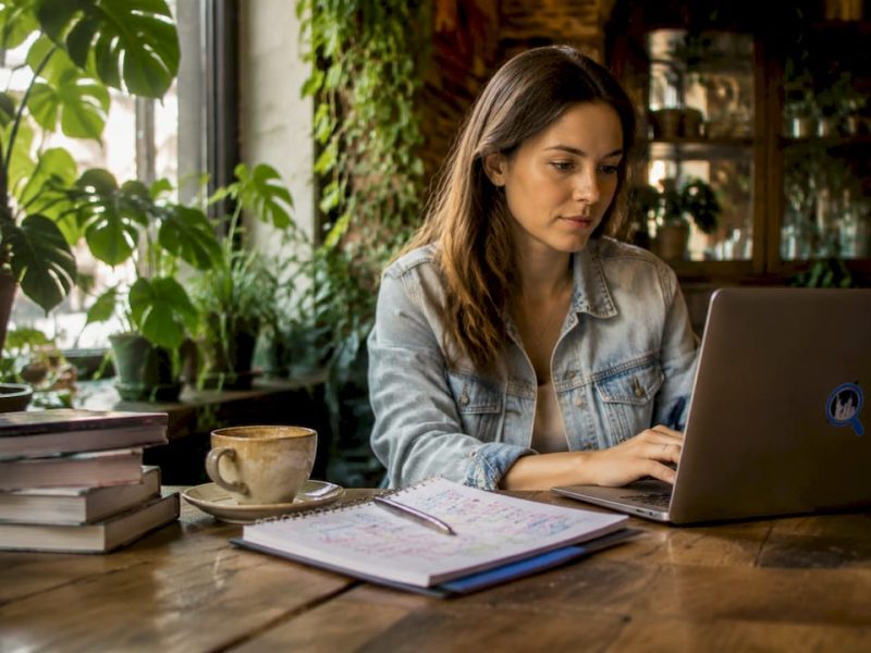 Woman planning NYC trip at home table