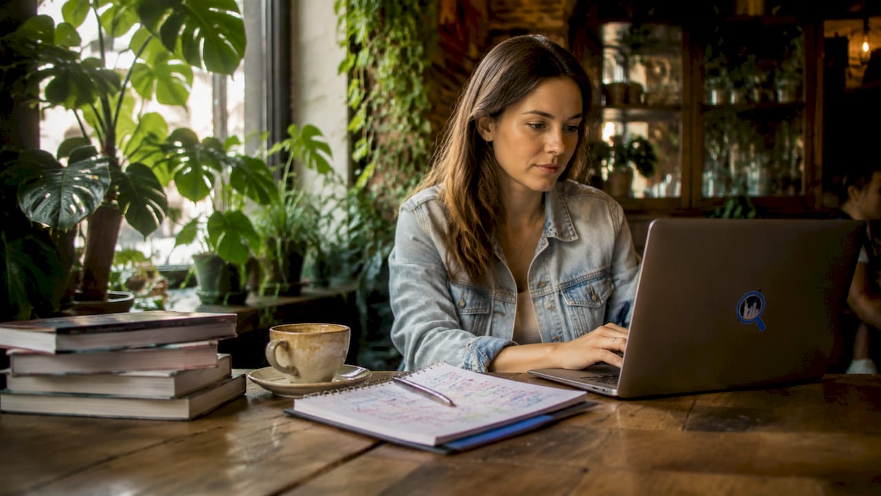 Woman planning NYC trip at home table