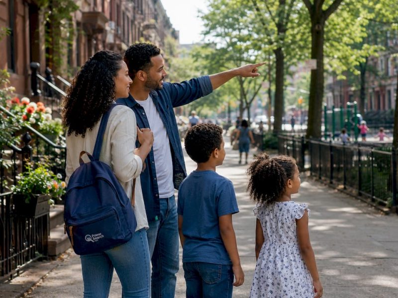 Family admiring NYC neighborhood park entrance