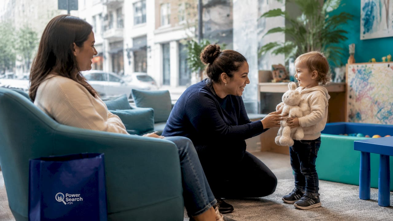 Parent and babysitter in NYC hotel room interacting with child