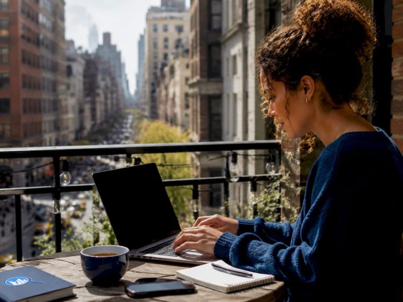 Woman booking NYC tours on laptop at home
