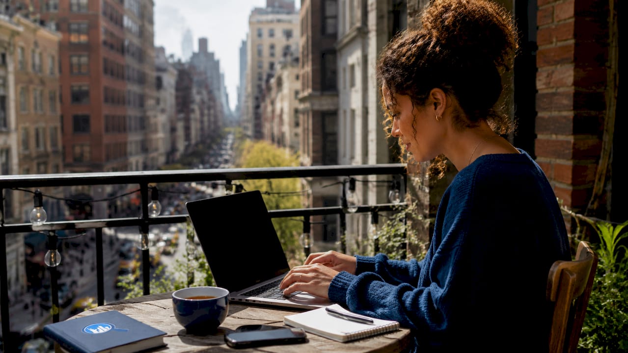 Woman booking NYC tours on laptop at home